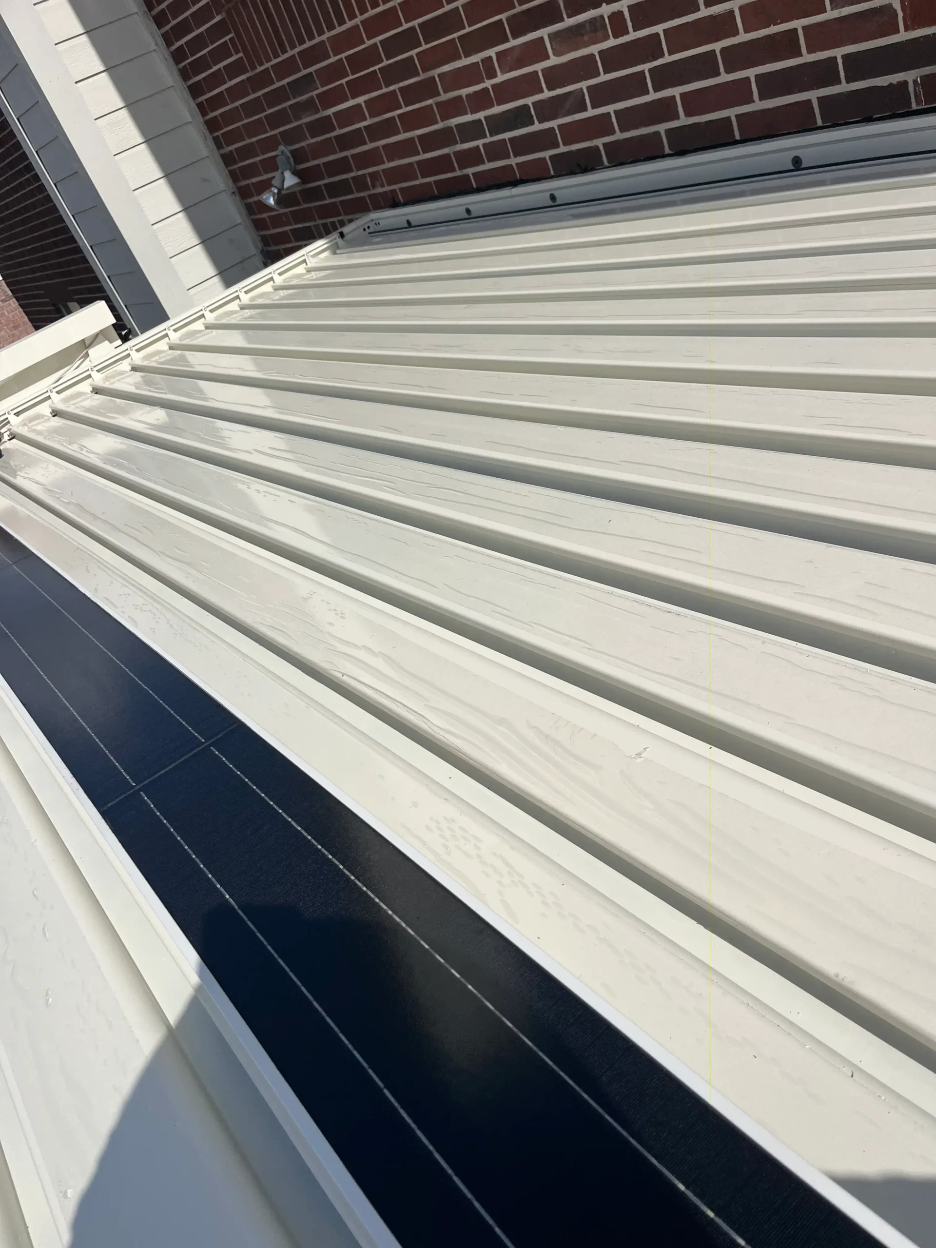 AT Louvre V Series solar-powered pergola with integrated photovoltaic panels on roof structure