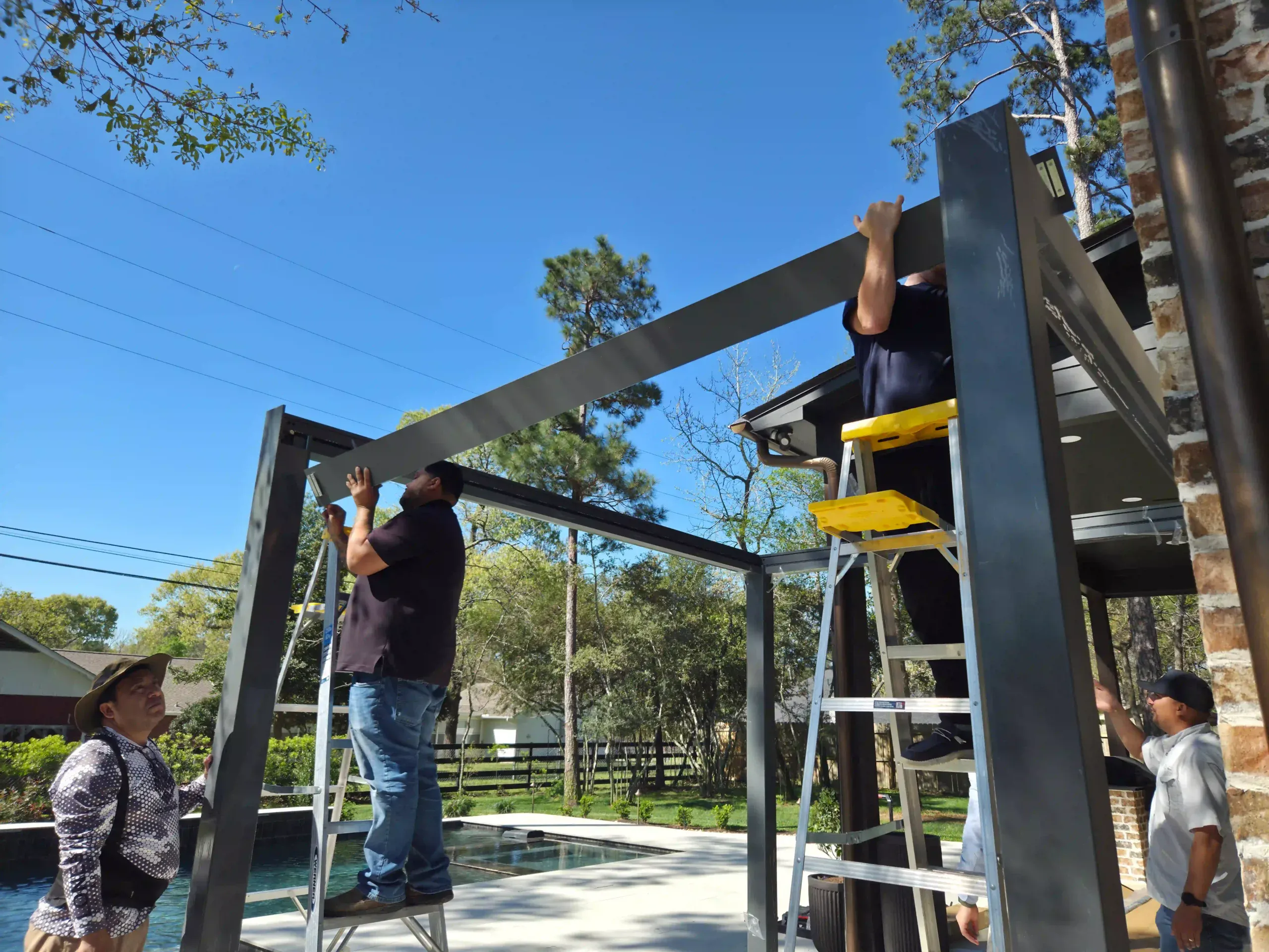 AT Louvre pergola frame installation with aluminum posts and cross-beams