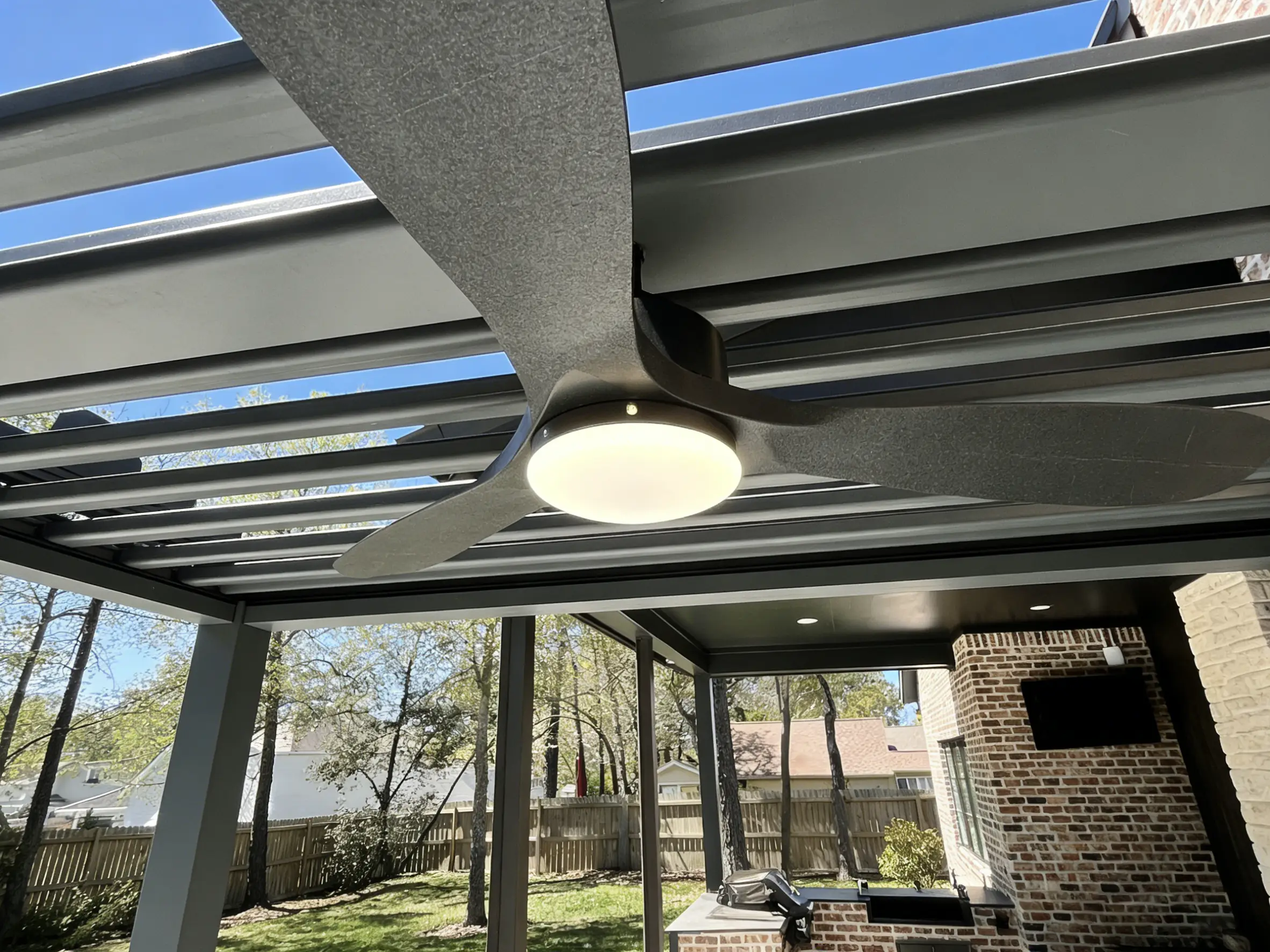 AT Louvre pergola built-in ceiling fan and recessed LED strip lighting integrated in frame